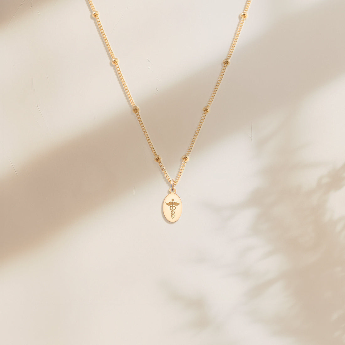 Caduceus Oval Disc Necklace
